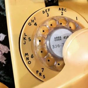 Close up of a yellow vintage phone
