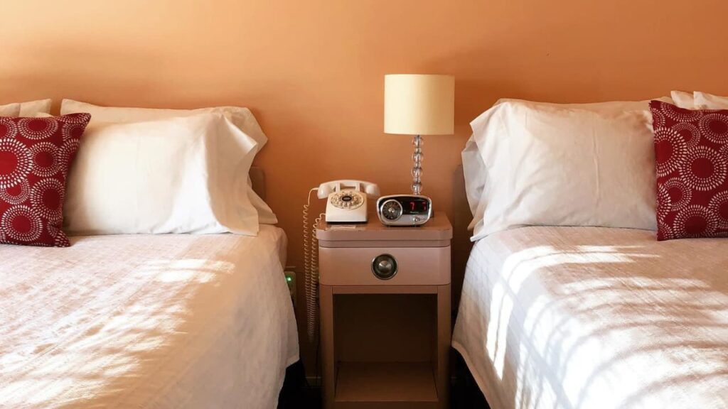 Two beds and a nightstand in between