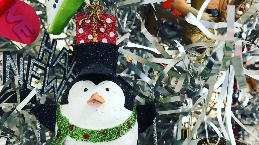 Close up of Christmas tree with penguin ornament